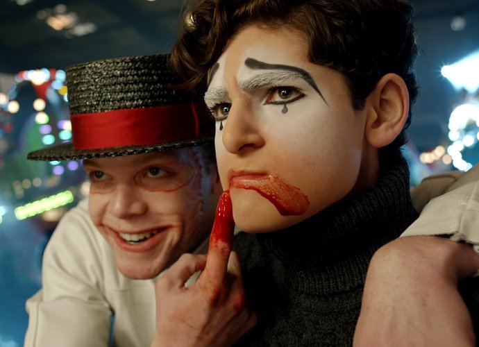 The Joker smeering blood across a mime's mouth to make a sad face.