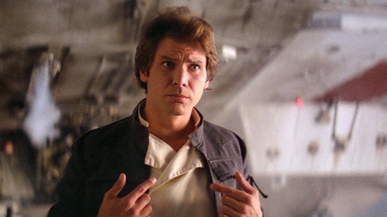 Harrison Ford as Han Solo standing in front of the Millenium Falcon.