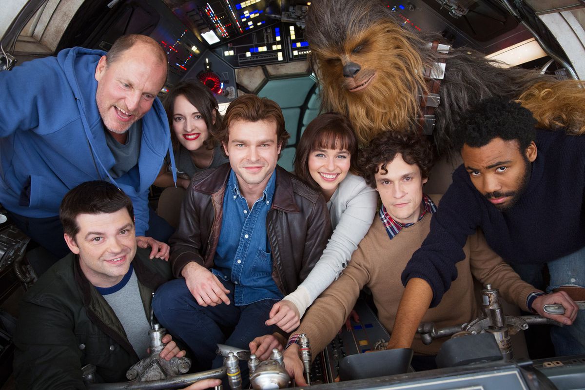A picture of the cast and original directors of Solo: A Star Wars Story, in the cockpit of the Millenium Falcon.
