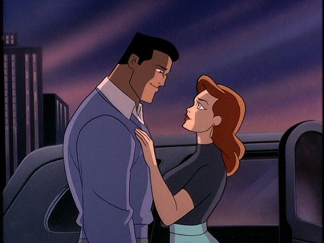 Bruce Wayne with a woman looking as if they're about to kiss.
